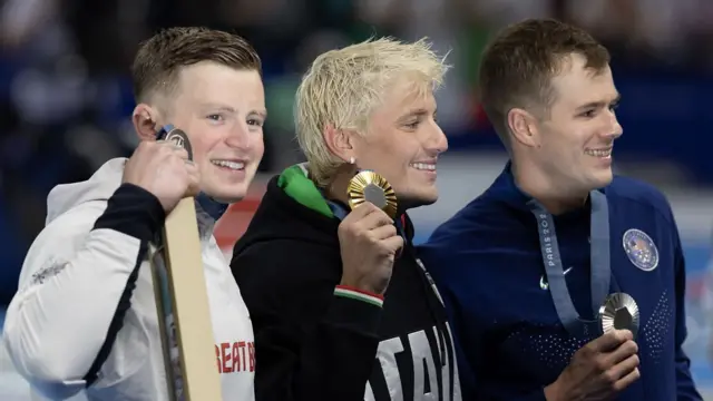 UK swimmer Adam Peaty holds his silver medal for the 100m breaststroke final beside gold medalist Nicolo Martinenghi and silver medalist Nic Fink (Credit: Getty Images)